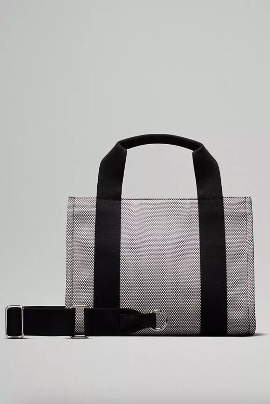 BNWT Lululemon Two-Tone Canvas Mini Tote Bag 4.5L in Anchor/Light Ivory (Category: Tote Bags) located in Singapore. Submitted by weiztay (Listing ID 1411620272, Image 2). Description: - Classic easy to match colour - Removable, adjustable shoulder strap - Front pocket to store your essentials - Clip a nano pack or keychain onto the D-ring - Snap closure - Zippered interior pocket - Interior drop-in pocket - Perfect for everyday use Bag dimensions