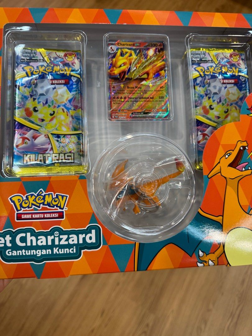 Pokemon Charizard Card Set with Keychain exclusive (Category: Raw Cards) located in Singapore. Submitted by zackerina (Listing ID 1391465984, Image 1). Description: - Brand new and sealed Pokemon Charizard set. - Includes: - Charizard card - 2 booster packs - Charizard keychain - Perfect for collectors or gifting. - Excellent condition..