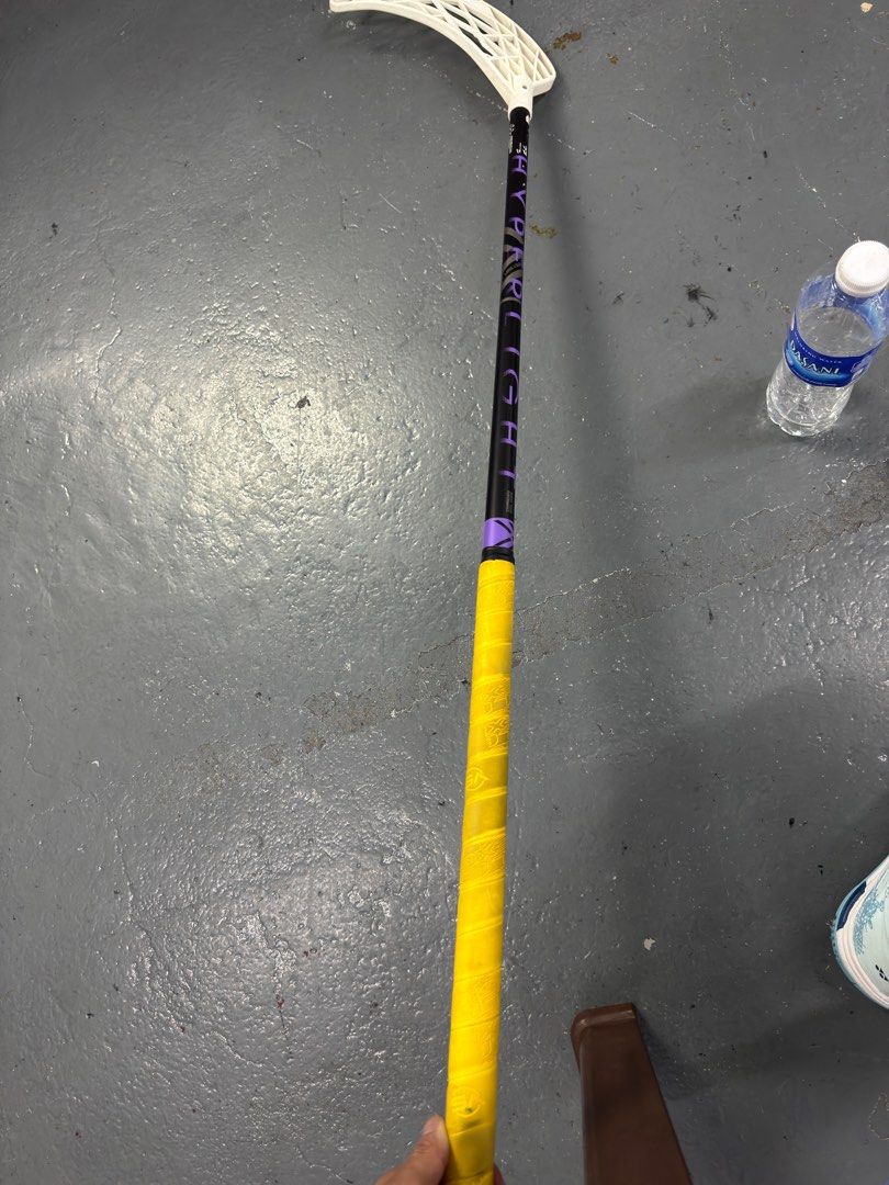 Hyperlight Floorball Stick (Category: Racket & Ball Sports) located in Singapore. Submitted by valueist (Listing ID 1391674764, Image 2). Description: - Used Hyperlight floorball stick - White blade - Black shaft with purple lettering - Yellow grip - Ideal for floorball enthusiasts.