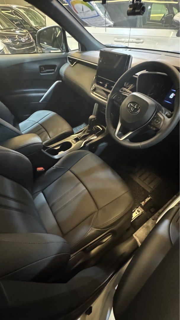 Toyota Corolla Cross 1.8A (Category: Parallel Imports) located in Singapore. Submitted by autozenbykenz (Listing ID 1414928783, Image 7). Description: Key Features & Specs: Powertrain: 1.8L Petrol Engine + Electric Motor with E-CVT Transmission. Power: Around 138 horsepower. Efficiency: Excellent fuel economy 26.2 km/L Technology: Toyota Safety Sense (Pre-Collision, Lane Departure Alert, etc.), 8-inch Multimedia System, Apple CarPlay/Android Auto