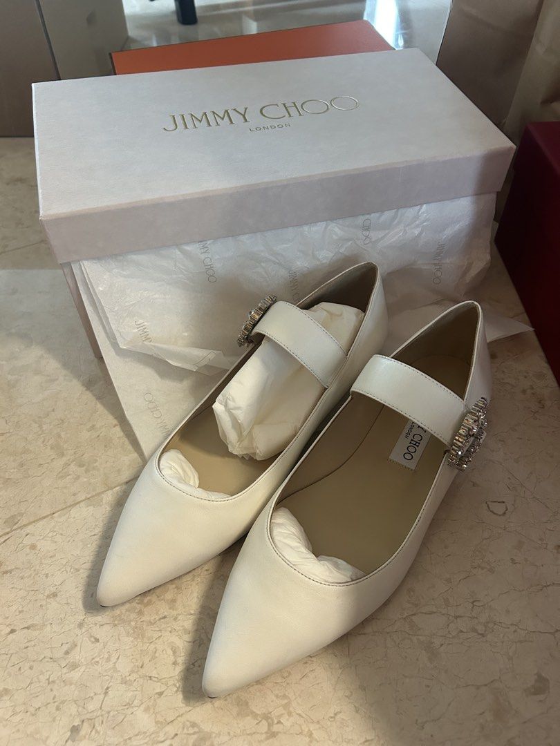 Jimmy Choo Cheri Flat - Milk - Size 39.5 (Category: Flats) located in Singapore. Submitted by 011284lynn (Listing ID 1421830373, Image 1). Description: - Brand new Jimmy Choo Cheri Flat - Color: Milk - Size: 39.5 - Features a crystal buckle - Comes with original box and packaging - Never worn.