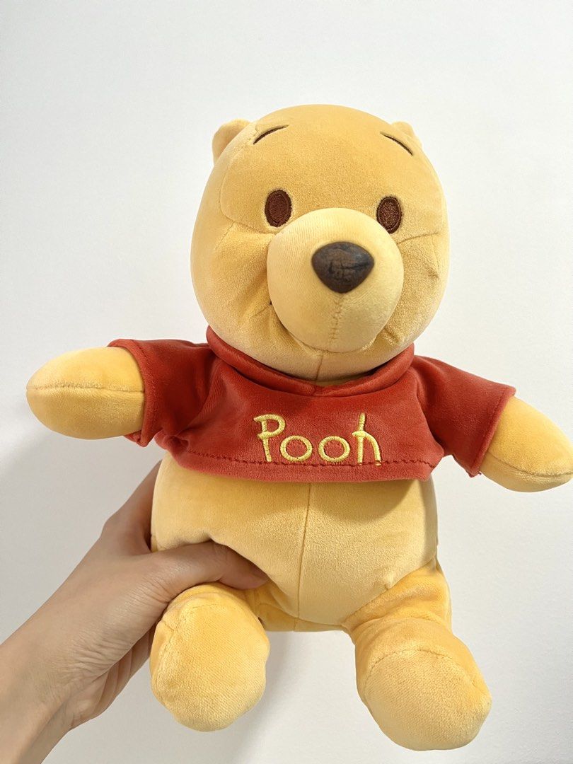 Disney Winnie the Pooh Plush Toy (Category: Plushies & Soft Toys) located in Singapore. Submitted by pocketgirl89757 (Listing ID 1431922482, Image 1). Description: - Height: about 25cm - Adorable Winnie the Pooh plush toy - Features classic Pooh design - Includes his signature red shirt - Perfect for Disney fans - Soft and cuddly - Ready for a new home!.
