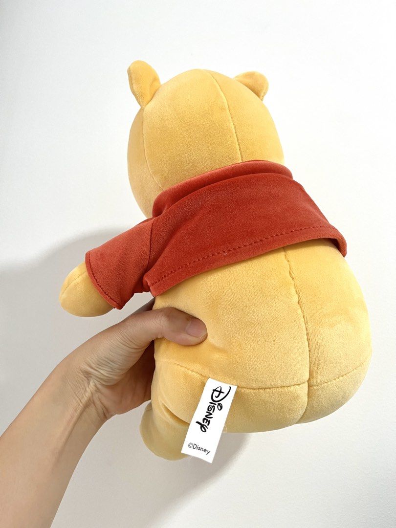 Disney Winnie the Pooh Plush Toy (Category: Plushies & Soft Toys) located in Singapore. Submitted by pocketgirl89757 (Listing ID 1431922482, Image 2). Description: - Height: about 25cm - Adorable Winnie the Pooh plush toy - Features classic Pooh design - Includes his signature red shirt - Perfect for Disney fans - Soft and cuddly - Ready for a new home!.