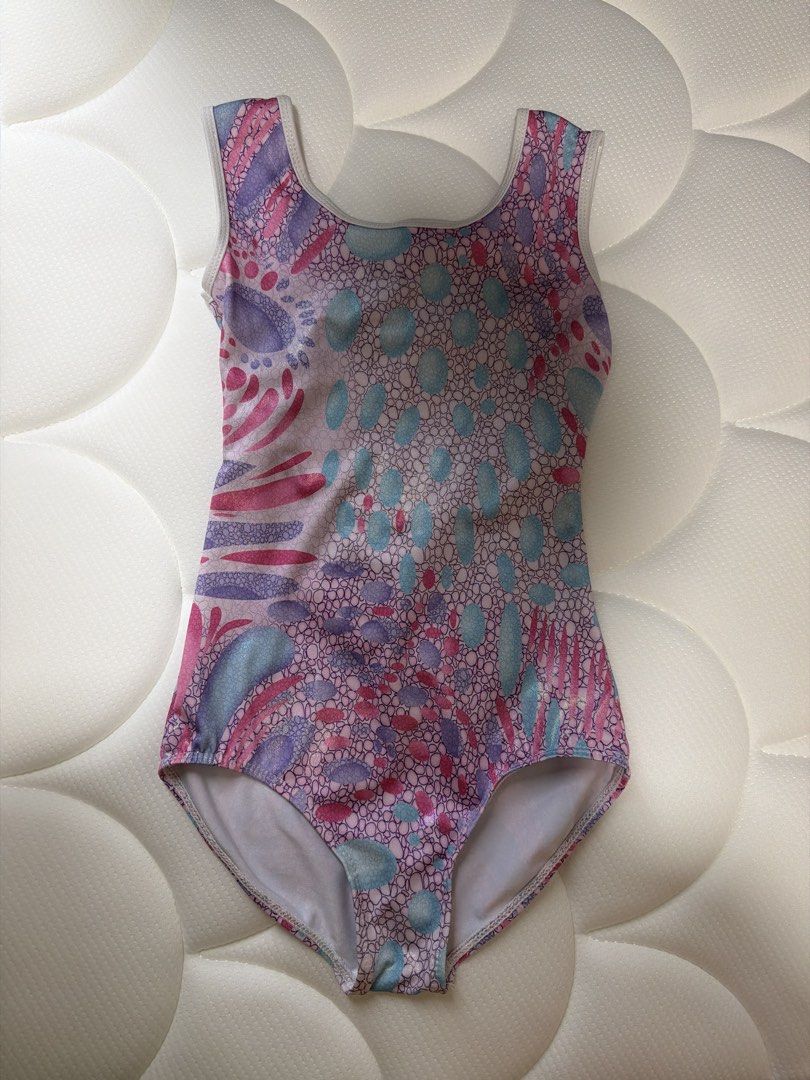 Girls' Gymnastics Leotard - Pink, Purple, and Blue (Category: Babies & Kids Fashion) located in Singapore. Submitted by cassandrahan (Listing ID 1433061165, Image 1). Description: - total length 57cm - Features a vibrant pattern with pink, purple, and blue accents. - Unique open back design with a purple panel. - Ideal for gymnastics or dance practice. .