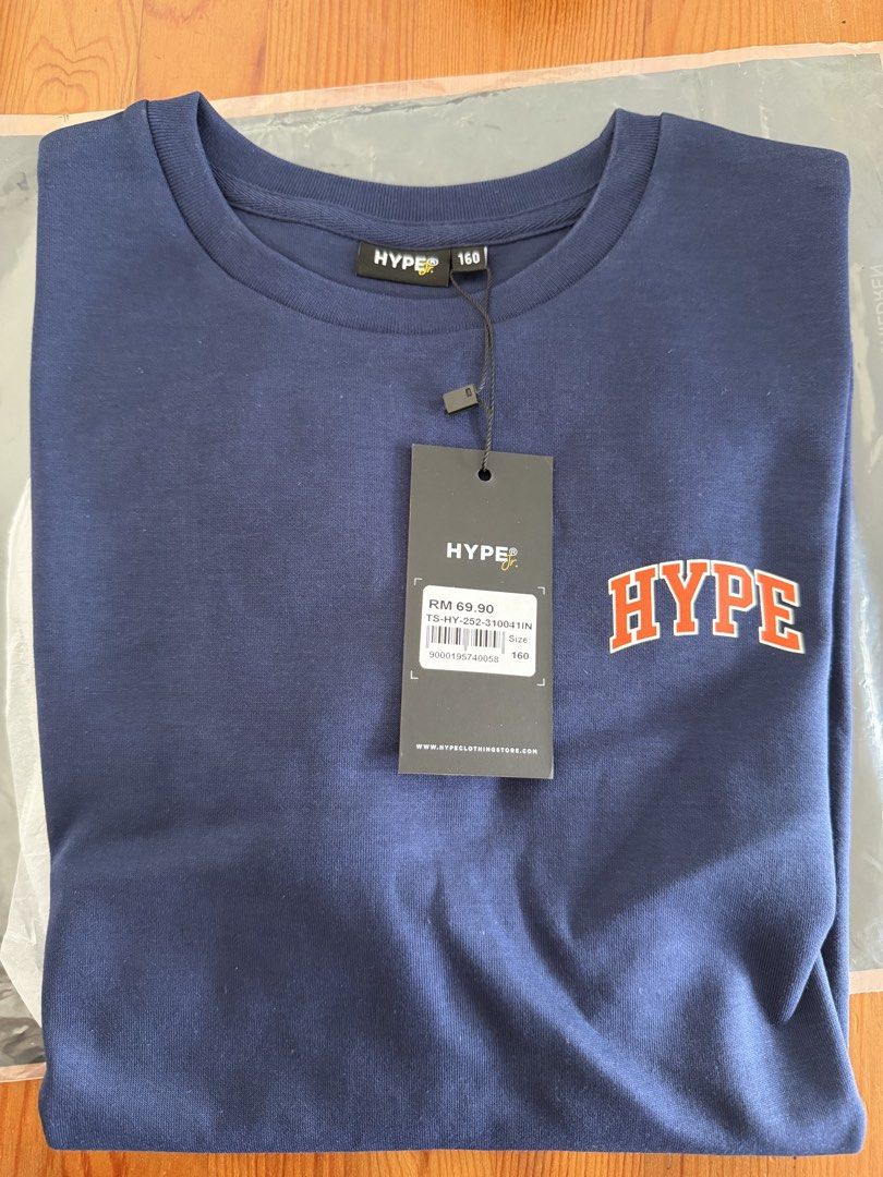 HYPE Navy Blue T-shirt - Size 160 - Brand New (Category: Babies & Kids Fashion) located in Singapore. Submitted by jr2224 (Listing ID 1438338943, Image 1). Description: - Brand new HYPE T-shirt - Navy blue color - Orange HYPE logo on front - Size 160 - With original tags - Perfect for casual wear Bought wrong size.