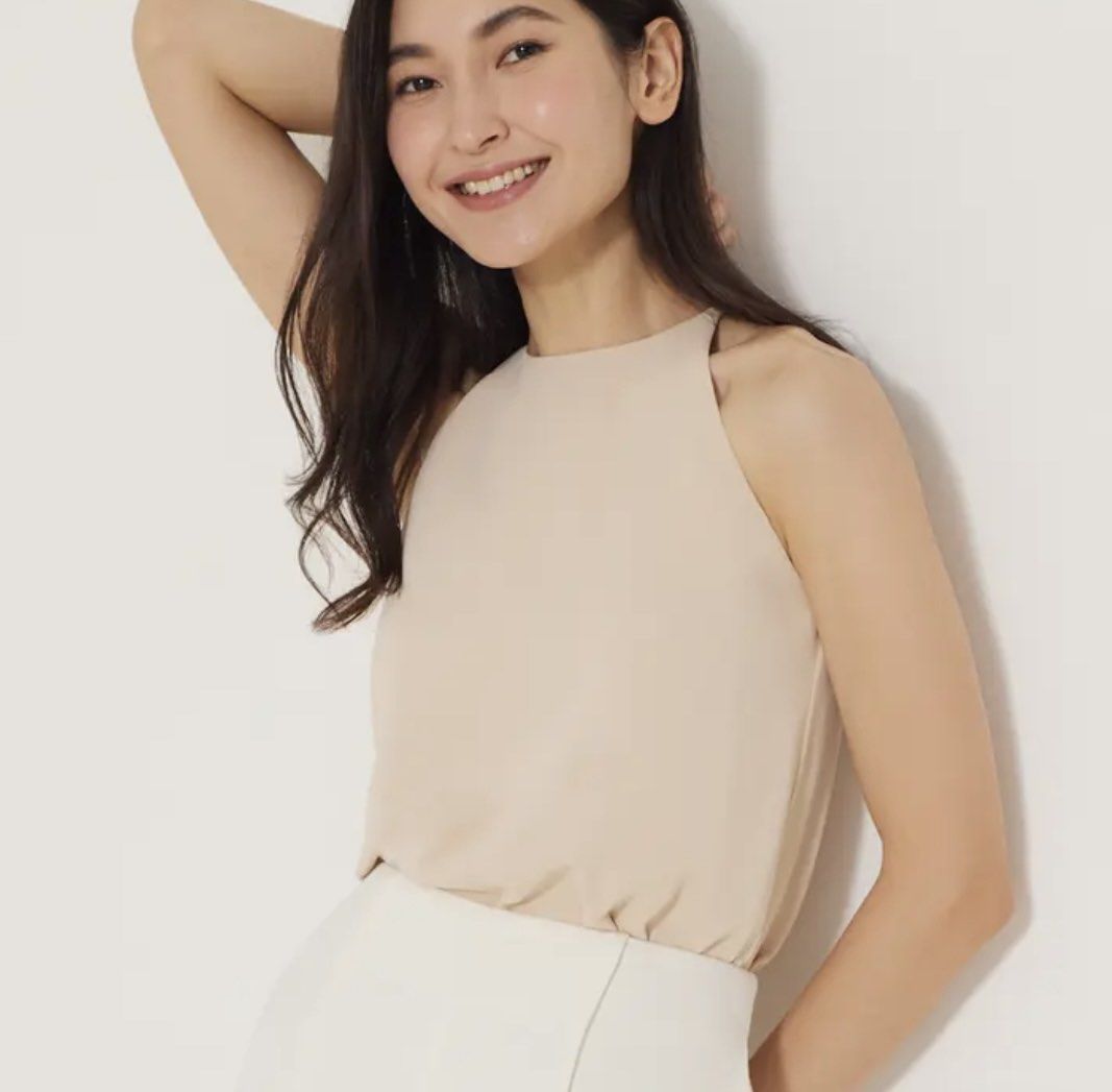 Love Bonito Callie Classic Halter Top (Beige) (Category: Sleeveless) located in Singapore. Submitted by windyhouse (Listing ID 1445154318, Image 1). Description: - Elegant beige halter neck top - Sleeveless design - Button closure at the back neck - Fabric with a slight sheen - Perfect for dressing up or down - Easily pairs with skirts or pants.