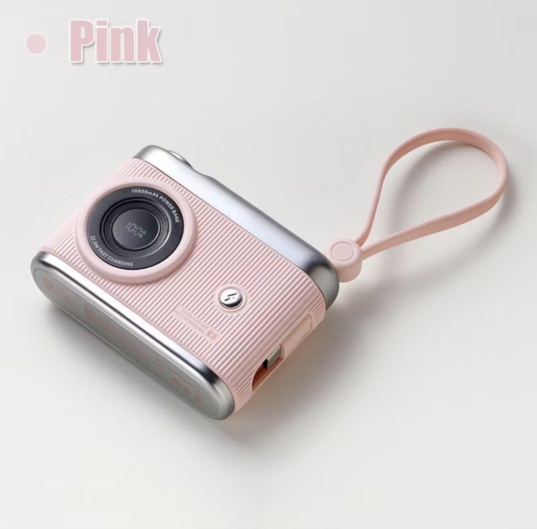 10000mAh Camera Power Bank PD 20W Fast Charging Pink (Category: Power Banks & Chargers) located in Singapore. Submitted by mintychococat (Listing ID 1445474302, Image 1). Description: - Adorable camera-shaped power bank - Compact palm size - 10000mAh capacity - PD 20W super fast charging (60% in 30 mins) - Bidirectional charging - Compatible with Apple devices - LED digital display for battery level - Lightweight and portable - Includes a conveni