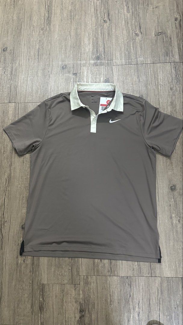 Nike Dri-FIT Golf Polo Shirt - Men's Large - Grey (Category: Tshirts & Polo Shirts) located in Singapore. Submitted by yassha (Listing ID 1450301378, Image 1). Description: - Grey Nike Dri-FIT Polo Shirt - Size: L - Features a light cream collar and white buttons - Iconic Nike swoosh logo on the chest - Material: 88% Polyester, 12% Spandex - Ideal for golf or everyday casual wear.