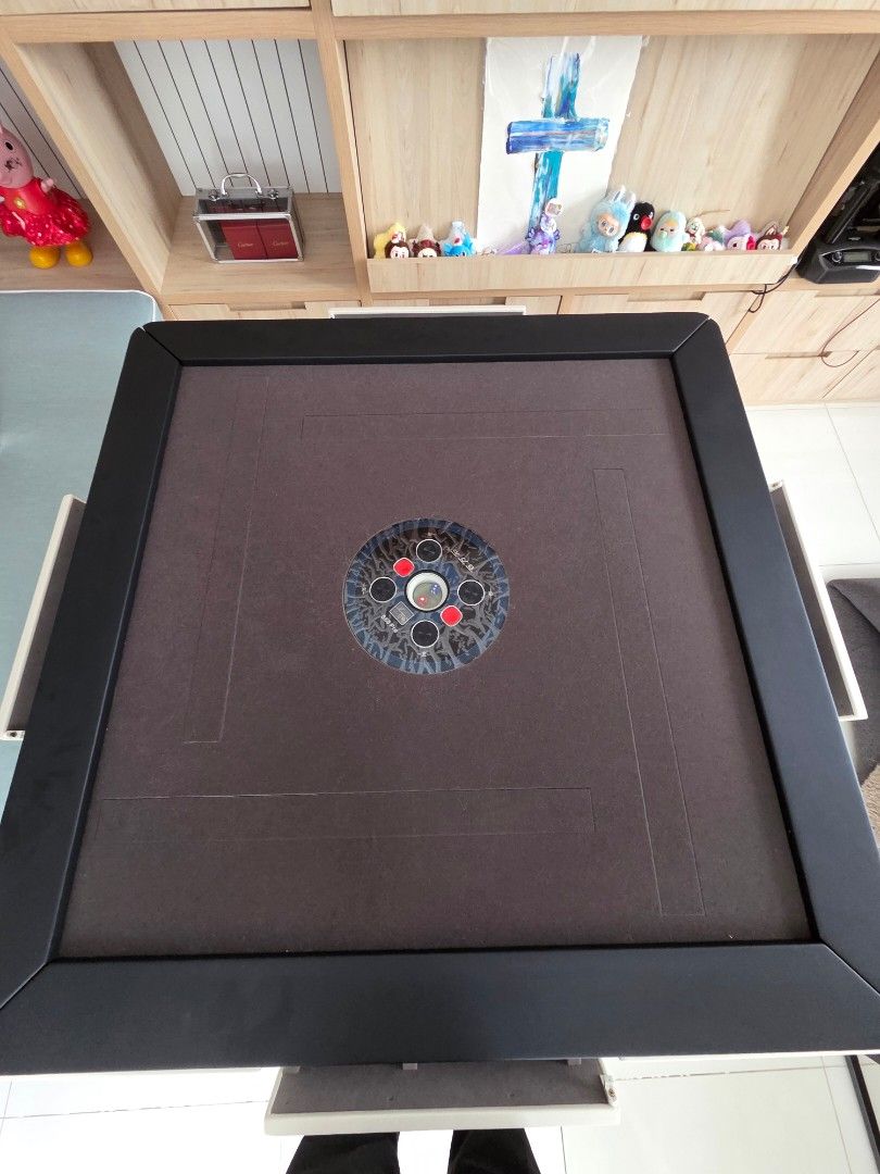 Automatic Mahjong Table with Built-in chips storage (Category: Tables & Sets) located in Singapore. Submitted by rexeter (Listing ID 1450455395, Image 3). Description: - Foldable Mahjong Table - Dark Brown Fabric Surface - Black Frame & White Casing - Built-in Storage Compartments for Tiles & Accessories - Folds Neatly for Easy Storage - Ideal for Game Nights.