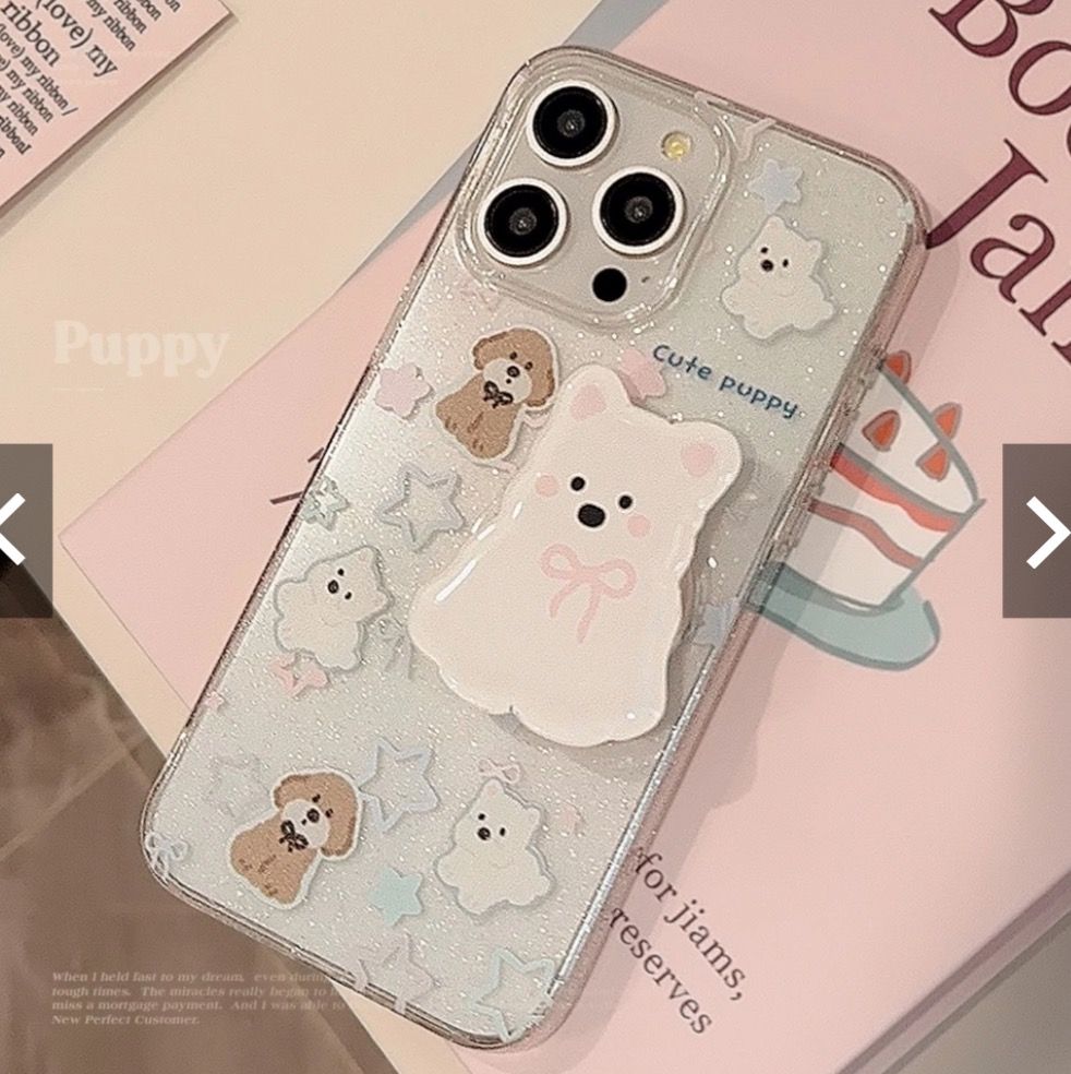 🌱Noro Bloomer🌱 iPhone apple aesthetic adorable sweet cute Cute Bear & Puppy Phone Case with Charm (Category: Cases & Sleeves) located in Singapore. Submitted by noro_bloomer (Listing ID 1450717399, Image 2). Description: - Super cute phone case - Clear glittery background - Adorable bear and puppy stickers - Fluffy pom-pom charm included - Beaded strap attached - Adds a sweet, charming touch - Ideal for gifting or personal use.