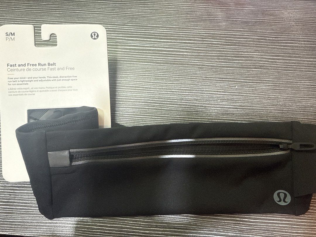 Lululemon Fast and Free Run Belt (Black) (Category: Purses & Pouches) located in Singapore. Submitted by poppingdaisies (Listing ID 1452207714, Image 1). Description: Lululemon Fast and Free Run Belt in Black Size S/M: 71cm - 81cm (28” - 32”) Brand new with tag Product Features: Zippered stretchy pocket keeps your phone close Side drop-in pockets to stash your key, cards, and gels Reflective details Adjustable low-bounce waistband has a buckle cl