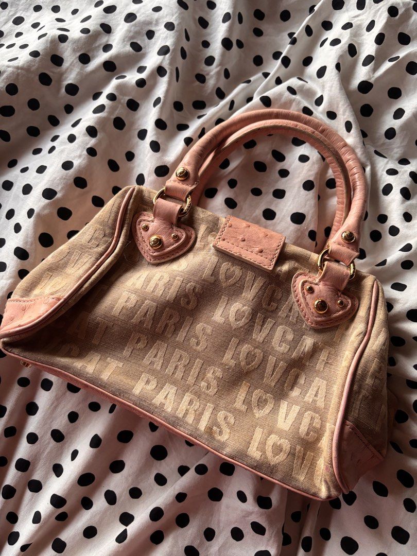 Lovcat Paris mini handbag (Category: Shoulder Bags) located in Singapore. Submitted by mw00ya (Listing ID 1447682825, Image 2). Description: - Cute Lovecat Paris handbag - Beige canvas with pink ostrich embossed trim - Features heart charms and gold hardware - Top handles show some signs of wear - Great for a pop of color - Plenty of space inside for your essentials.
