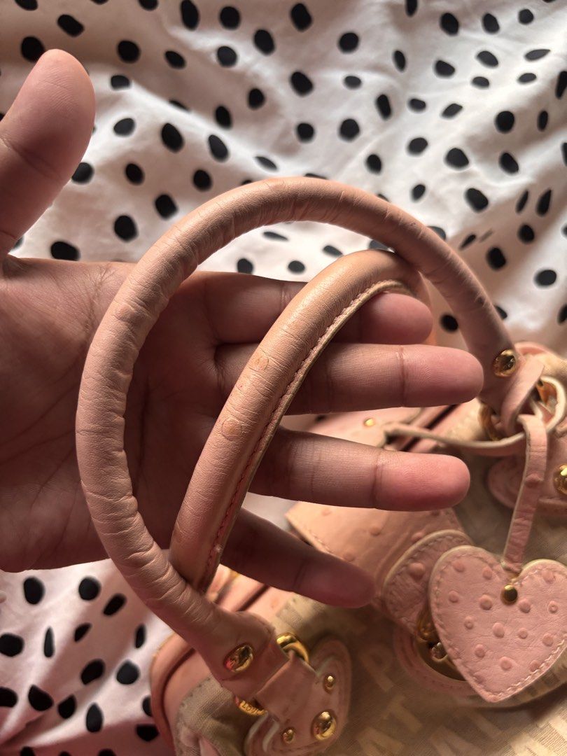 Lovcat Paris mini handbag (Category: Shoulder Bags) located in Singapore. Submitted by mw00ya (Listing ID 1447682825, Image 4). Description: - Cute Lovecat Paris handbag - Beige canvas with pink ostrich embossed trim - Features heart charms and gold hardware - Top handles show some signs of wear - Great for a pop of color - Plenty of space inside for your essentials.