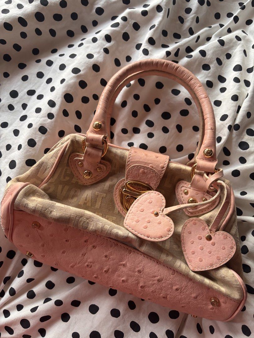 Lovcat Paris mini handbag (Category: Shoulder Bags) located in Singapore. Submitted by mw00ya (Listing ID 1447682825, Image 1). Description: - Cute Lovecat Paris handbag - Beige canvas with pink ostrich embossed trim - Features heart charms and gold hardware - Top handles show some signs of wear - Great for a pop of color - Plenty of space inside for your essentials.