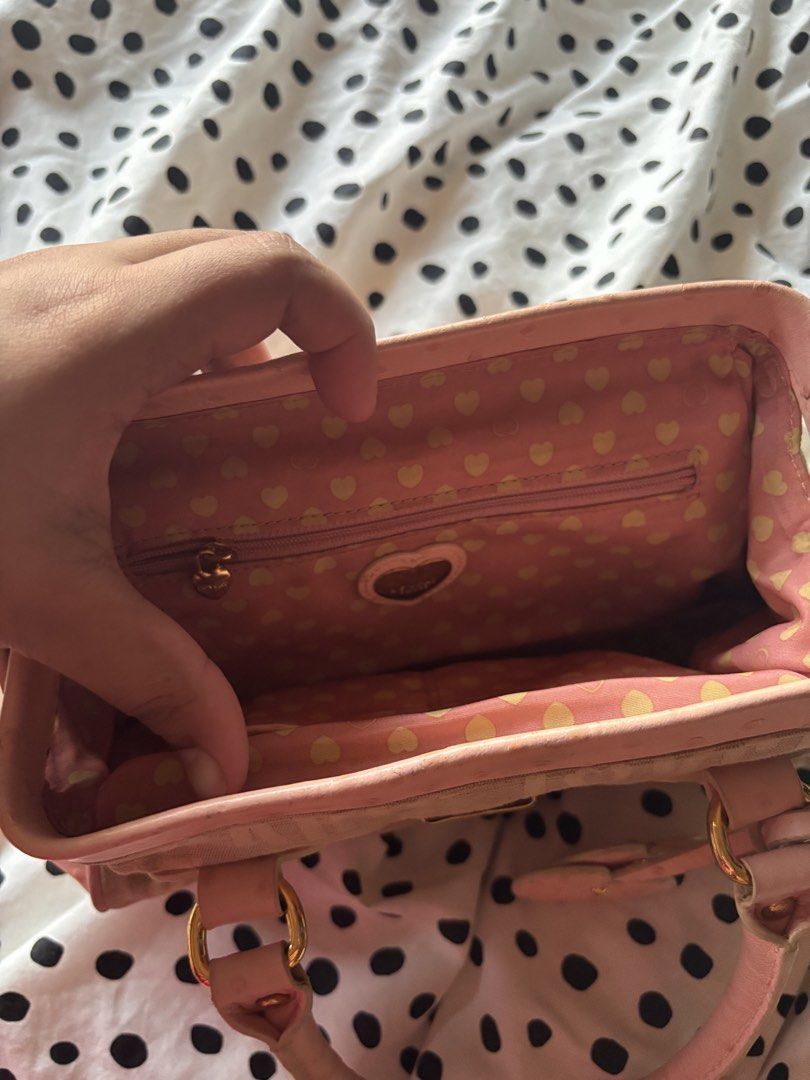 Lovcat Paris mini handbag (Category: Shoulder Bags) located in Singapore. Submitted by mw00ya (Listing ID 1447682825, Image 6). Description: - Cute Lovecat Paris handbag - Beige canvas with pink ostrich embossed trim - Features heart charms and gold hardware - Top handles show some signs of wear - Great for a pop of color - Plenty of space inside for your essentials.