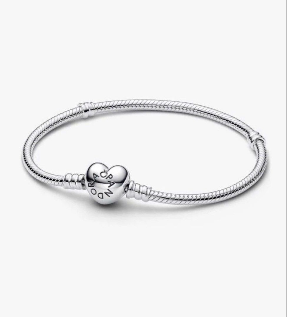 Pandora Sterling Logo Heart Clasp Silver Bracelet with December Blue Signature Heart Crystal Charms (Category: Bracelets) located in Singapore. Submitted by whitespade_ (Listing ID 1453181644, Image 1). Description: - Genuine Pandora sterling silver bracelet - Features a beautiful heart clasp - Includes 3 charms: 1 blue-stoned heart charm, 2 small silver ball charms - Ideal for expanding your Pandora collection or starting a new one - Sold as a c