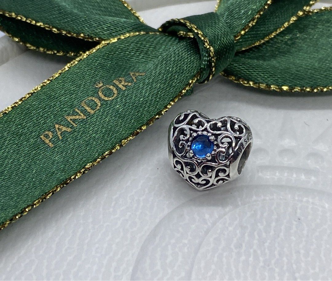 Pandora Sterling Logo Heart Clasp Silver Bracelet with December Blue Signature Heart Crystal Charms (Category: Bracelets) located in Singapore. Submitted by whitespade_ (Listing ID 1453181644, Image 2). Description: - Genuine Pandora sterling silver bracelet - Features a beautiful heart clasp - Includes 3 charms: 1 blue-stoned heart charm, 2 small silver ball charms - Ideal for expanding your Pandora collection or starting a new one - Sold as a c