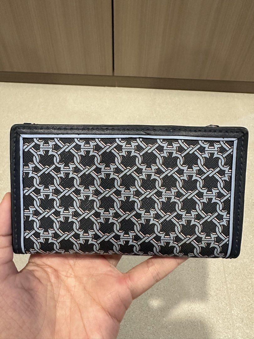 Kate Spade Blue link patterned lock bi fold card holder wallet (Category: Wallets & Card Holders) located in Singapore. Submitted by whitespade_ (Listing ID 1456009460, Image 3). Description: - Brand: Kate Spade - Type: Bi-fold card holder wallet - Design: Blue link pattern with gold 'Kate Spade New York' logo - Interior: Multiple card slots, clear ID window, zippered compartment, able to put coins and cards - Color: Blue and navy - Features: Com