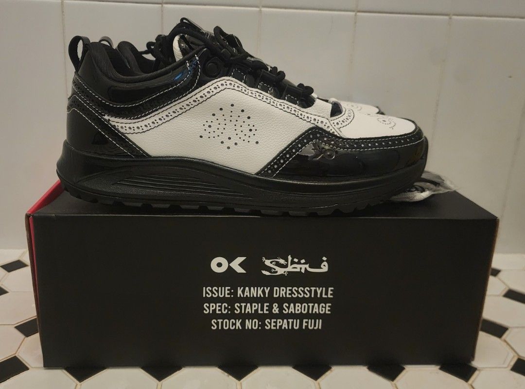 STAPLE x Sbtg x Kanky (Category: Sneakers) located in Singapore. Submitted by jemwong (Listing ID 1456141394, Image 3). Description: - Brand: STAPLE x SBTG x Kanky - Size: EU 42 (Men's Footwear) - Color: Black and White - Design: Classic silhouette with a mix of patent finishes, detailed stitching, and perforated accents. - Condition: BNIB - Features: Unique collaboration piece. - Meetup Location: Skyparc@Dawson (Blk 96 Dawson Road, 141096) Viewi