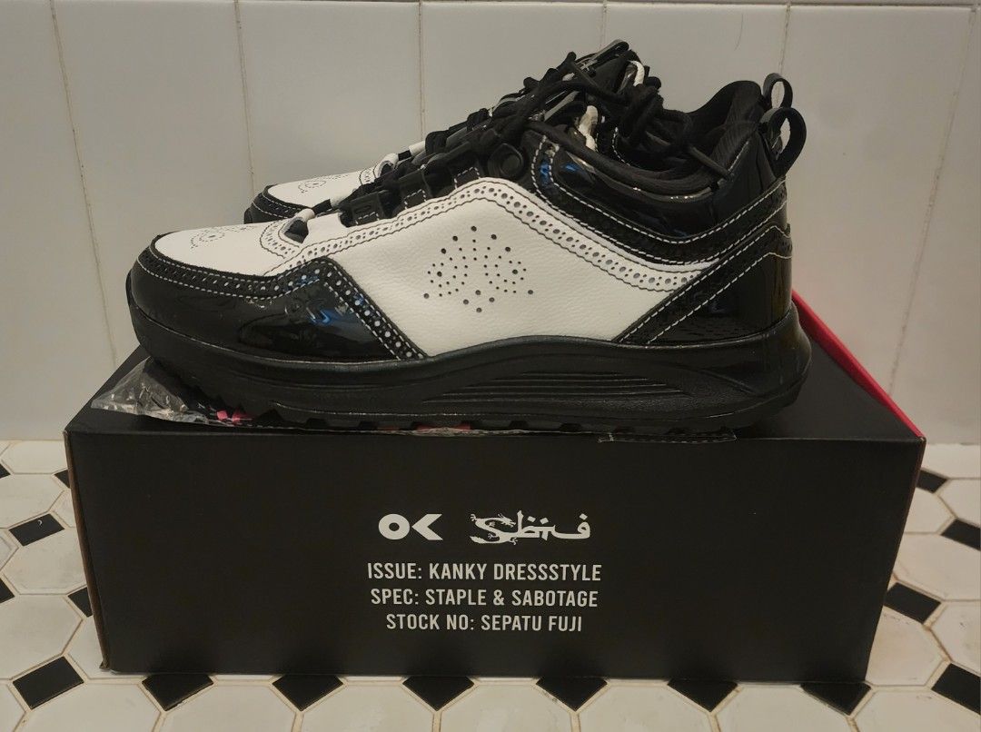 STAPLE x Sbtg x Kanky (Category: Sneakers) located in Singapore. Submitted by jemwong (Listing ID 1456141394, Image 1). Description: - Brand: STAPLE x SBTG x Kanky - Size: EU 42 (Men's Footwear) - Color: Black and White - Design: Classic silhouette with a mix of patent finishes, detailed stitching, and perforated accents. - Condition: BNIB - Features: Unique collaboration piece. - Meetup Location: Skyparc@Dawson (Blk 96 Dawson Road, 141096) Viewi