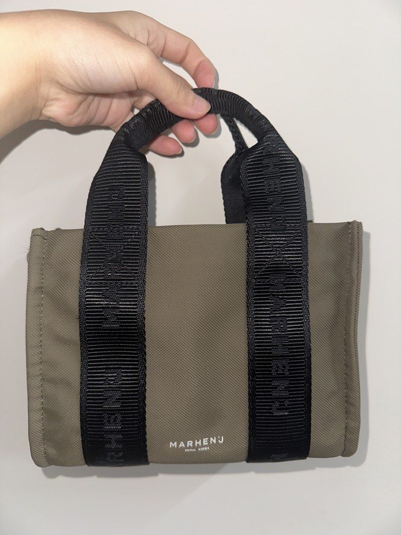 MARHEN.J Milly Nano Bag with Bonus Brand New Detachable Pouch (Category: Tote Bags) located in Singapore. Submitted by hazelnutsabi (Listing ID 1456932862, Image 2). Description: - MARHEN.J tote bag - Color: Olive Green - Includes detachable crossbody strap - Comes with a small zippered pouch - Made in Korea - Zipper closure for main compartment - Spacious interior - Ideal for daily use.