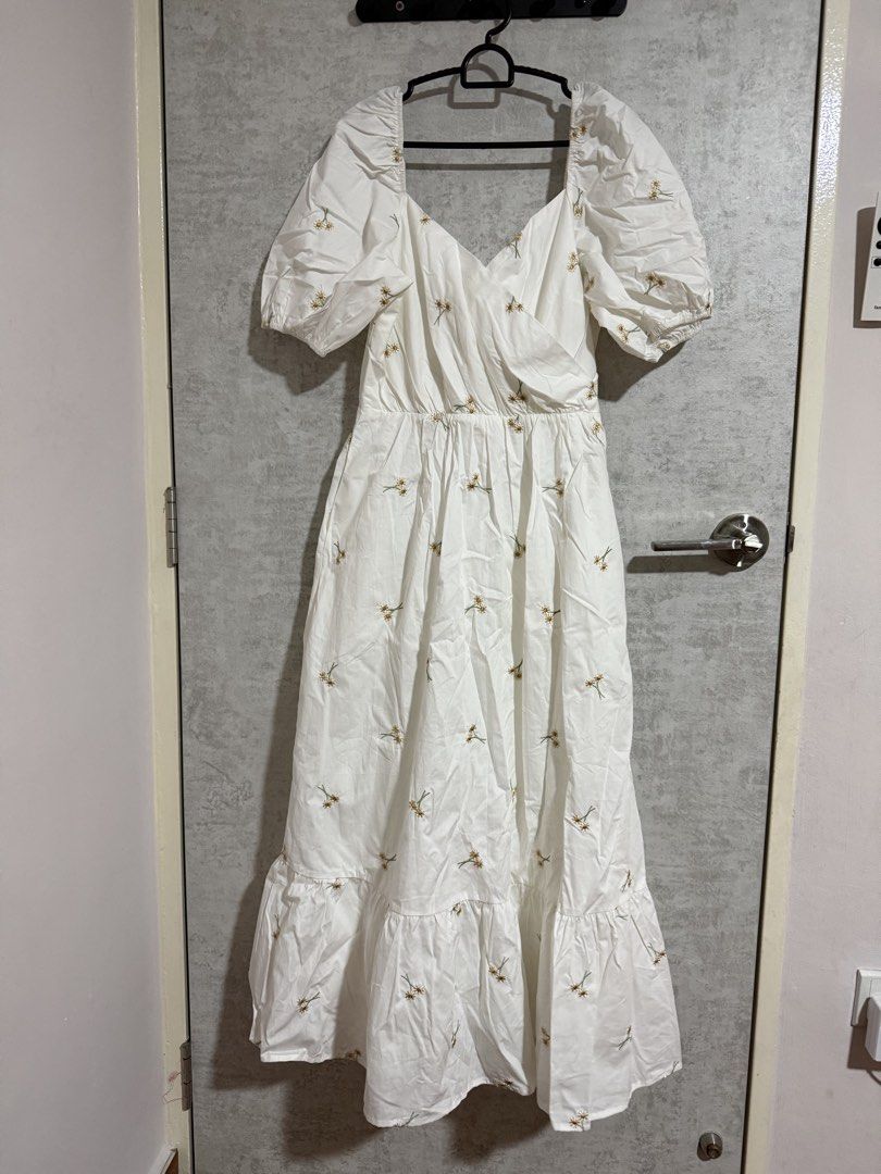 Lovengold White Puff Sleeve Midi Dress with Daisy Embroidery (Category: Dresses) located in Singapore. Submitted by ps1988 (Listing ID 1457186678, Image 1). Description: - Brand: Lovengold - Color: White - Style: Midi Dress - Size: M - Features: Puff sleeves, sweetheart neckline, all-over daisy embroidery, elasticated waist, ruffled hemline - Occasion: Perfect for summer outings.