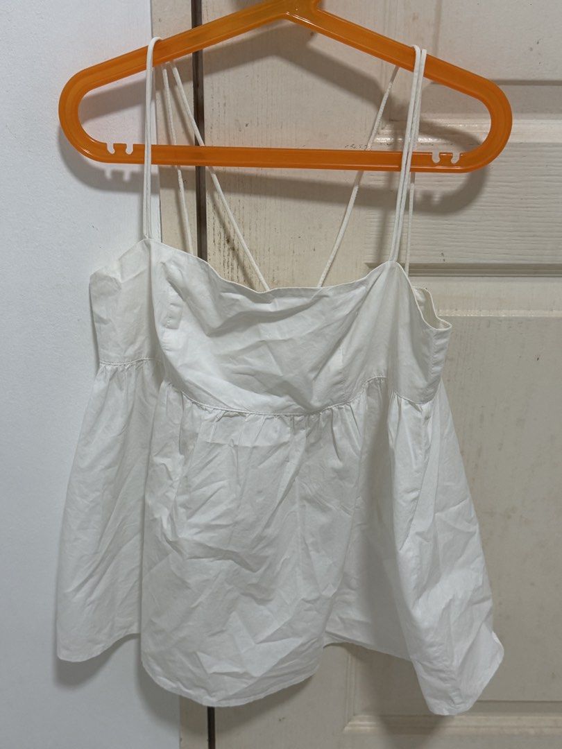 The Editor's Market White Spaghetti Strap Babydoll Top (Category: Sleeveless) located in Singapore. Submitted by geezck06 (Listing ID 1457292180, Image 1). Description: - White babydoll top from The Editor's Market - Spaghetti straps with criss-cross back detail - Zipper closure at the back - Flattering gathered waist - Easy to style for casual or dressy occasions - Great for summer - Thrifted from thryft but never won before - Self collect from 