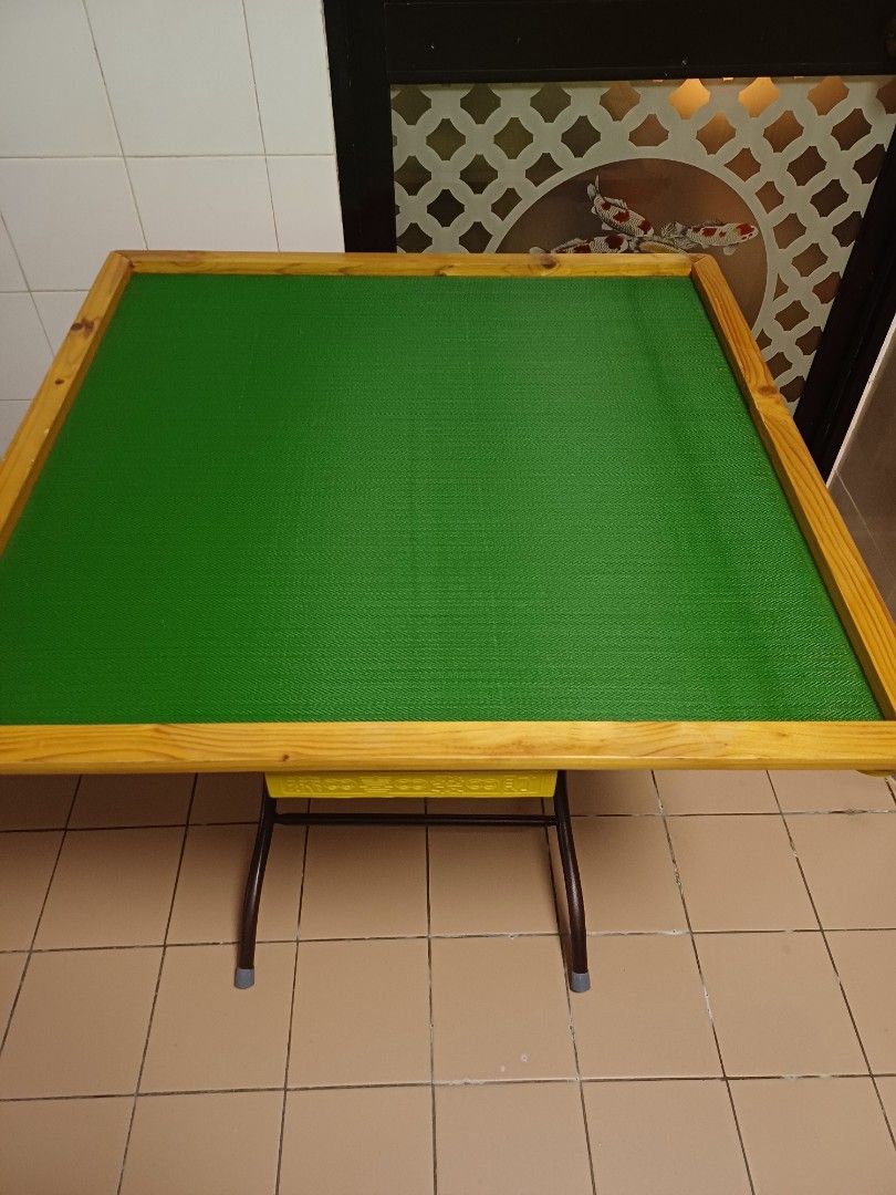 Foldable Mahjong Table with Green Surface (Category: Tables & Sets) located in Singapore. Submitted by joanne23 (Listing ID 1458144451, Image 1). Description: - Foldable Mahjong Table - Vibrant Green Playing Surface - Wooden Frame - Sturdy Metal Legs - Folds for Easy Storage - Ideal for Game Nights.
