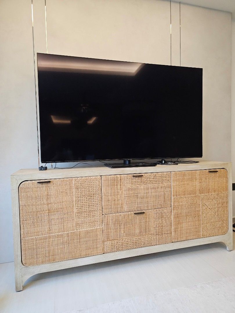 Rooma Rattan TV Console Cabinet with Storage (Category: TV Consoles) located in Singapore. Submitted by sherryssyed (Listing ID 1458391252, Image 1). Description: - Rooma TV console -Light wood TV console - Rattan detailing on doors and drawers - Ample storage space - Features two cabinets with shelves - Includes multiple drawers - Black handles - Ideal for organizing your living room - Approximate dimensions: 1.8m length - Self collect at Tampin