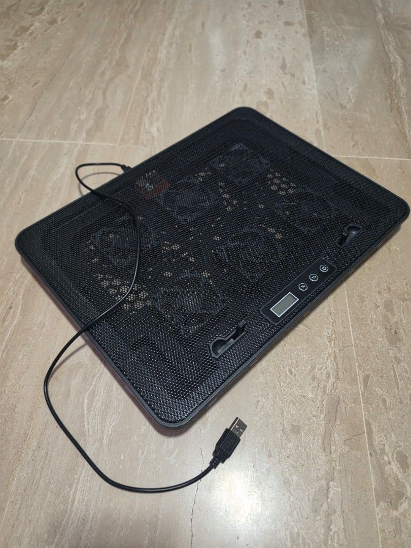 Black Laptop Stand/Cooling Pad with USB Cable (Category: Laptops & Notebooks) located in Singapore. Submitted by siako (Listing ID 1458606530, Image 2). Description: - Black laptop cooling pad/stand - Multiple fans for excellent airflow - Mesh top design - Small digital display on top - Adjustable angle for comfortable use - Includes USB cable for power - Keeps your laptop cool during long sessions - Multi speed fans.