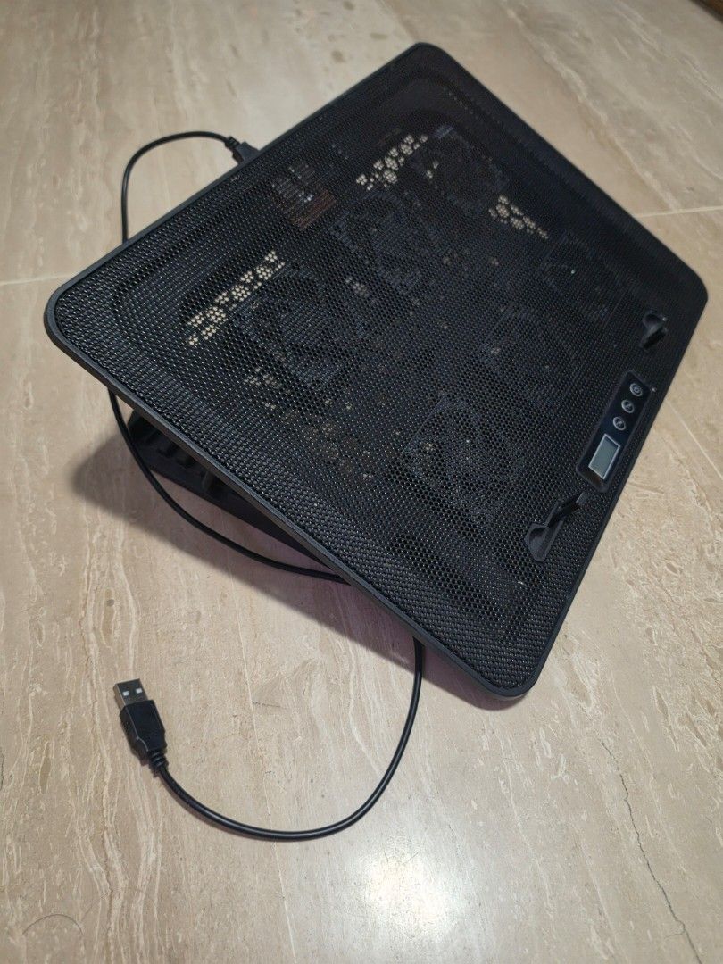 Black Laptop Stand/Cooling Pad with USB Cable (Category: Laptops & Notebooks) located in Singapore. Submitted by siako (Listing ID 1458606530, Image 1). Description: - Black laptop cooling pad/stand - Multiple fans for excellent airflow - Mesh top design - Small digital display on top - Adjustable angle for comfortable use - Includes USB cable for power - Keeps your laptop cool during long sessions - Multi speed fans.