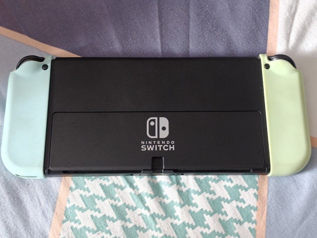 Nintendo Switch OLED White with Accessories (Category: Nintendo) located in Singapore. Submitted by cruor42 (Listing ID 1458575556, Image 2). Description: Nintendo Switch OLED Model (White) Includes all original accessories as well as additional third party accessories as pictured -power and HDMI cable included Cute Animal Crossing themed case, dock cover, joycons and console cover and game cartridge storage case Includes Mario themed big carryin