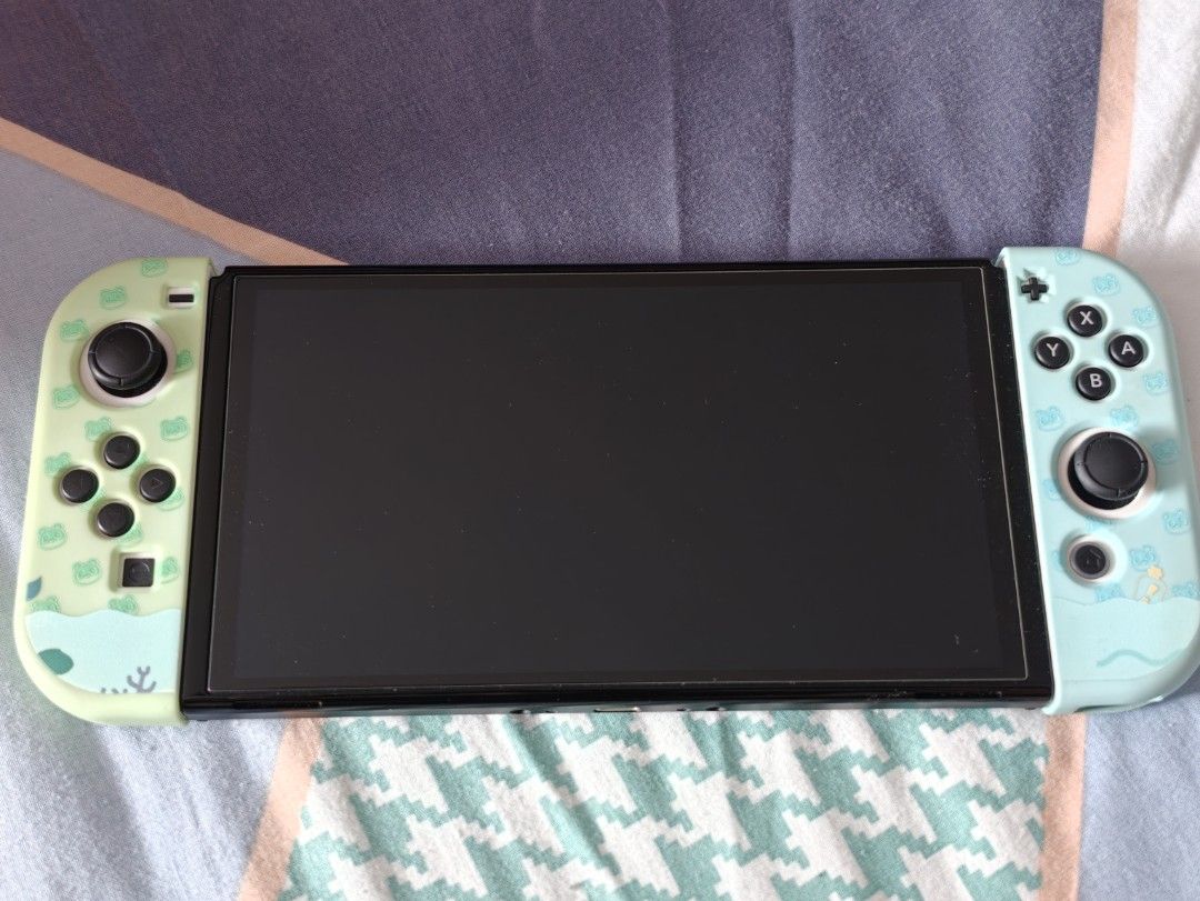 Nintendo Switch OLED White with Accessories (Category: Nintendo) located in Singapore. Submitted by cruor42 (Listing ID 1458575556, Image 3). Description: Nintendo Switch OLED Model (White) Includes all original accessories as well as additional third party accessories as pictured -power and HDMI cable included Cute Animal Crossing themed case, dock cover, joycons and console cover and game cartridge storage case Includes Mario themed big carryin