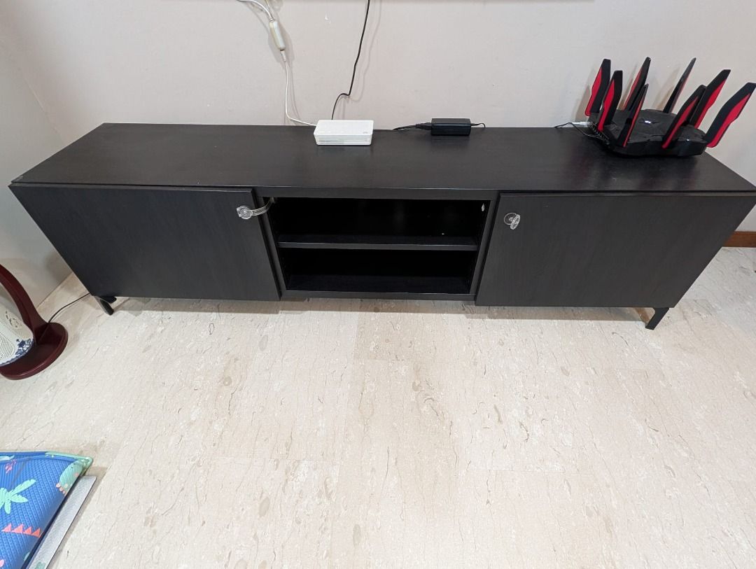 Black TV Console Cabinet with Storage (Category: TV Consoles) located in Singapore. Submitted by apracho1987 (Listing ID 1458840575, Image 3). Description: Move-out sale! Sleek and modern black TV console with two side cabinets for concealed storage and a two-tier open shelf in the centre for easy access to media devices and accessories. Features slim black legs, generous storage space, and a versatile minimalist design that complements most livi