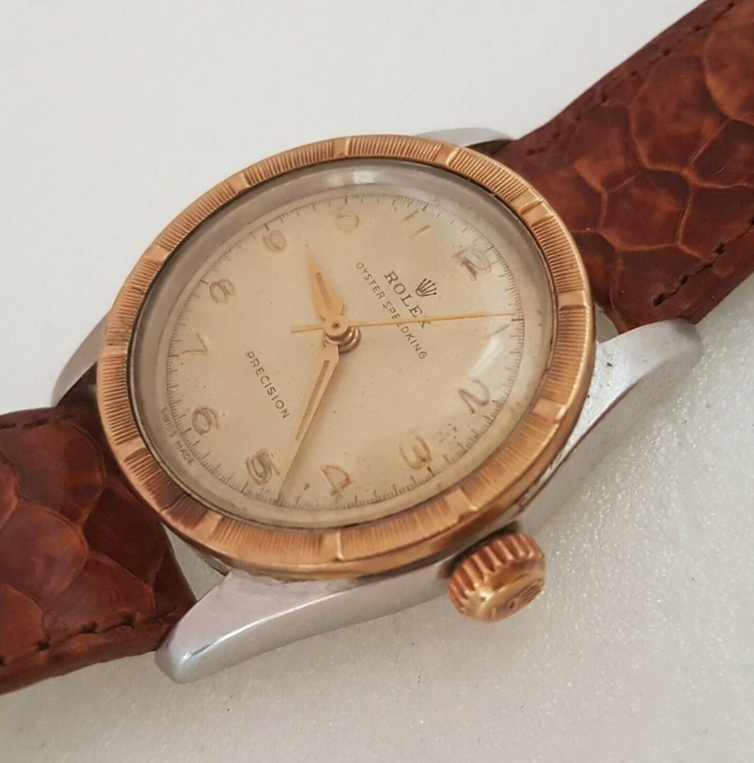 Vintage 1950’s Rolex Speed King Wristwatch, SWISS Made, Distinctive Engine-Turned Bezel, Caliber 5021, Manual Winding Watch, 18 Rubies, Retro 2-Tone Design, Oyster Precision, Tropical Dial, Timeless Classic, Luxury Timepiece, For Collectors, Hobbyists (Category: Watches) located in Singapore. Submitted by discountshop (Listing ID 1453691641, Image 4). Description: The Rolex Speed King is a vintage, manually wound midsize watch, Rolex Oyster Speed