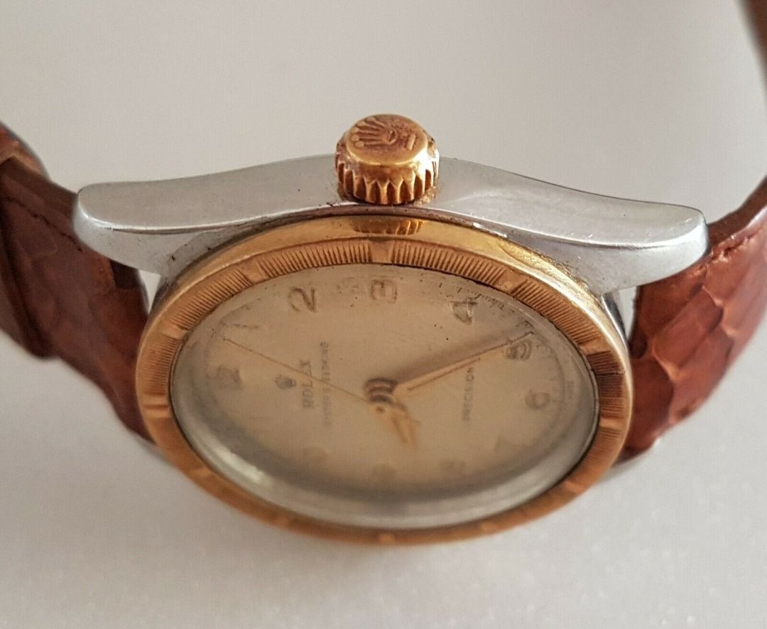Vintage 1950’s Rolex Speed King Wristwatch, SWISS Made, Distinctive Engine-Turned Bezel, Caliber 5021, Manual Winding Watch, 18 Rubies, Retro 2-Tone Design, Oyster Precision, Tropical Dial, Timeless Classic, Luxury Timepiece, For Collectors, Hobbyists (Category: Watches) located in Singapore. Submitted by discountshop (Listing ID 1453691641, Image 3). Description: The Rolex Speed King is a vintage, manually wound midsize watch, Rolex Oyster Speed