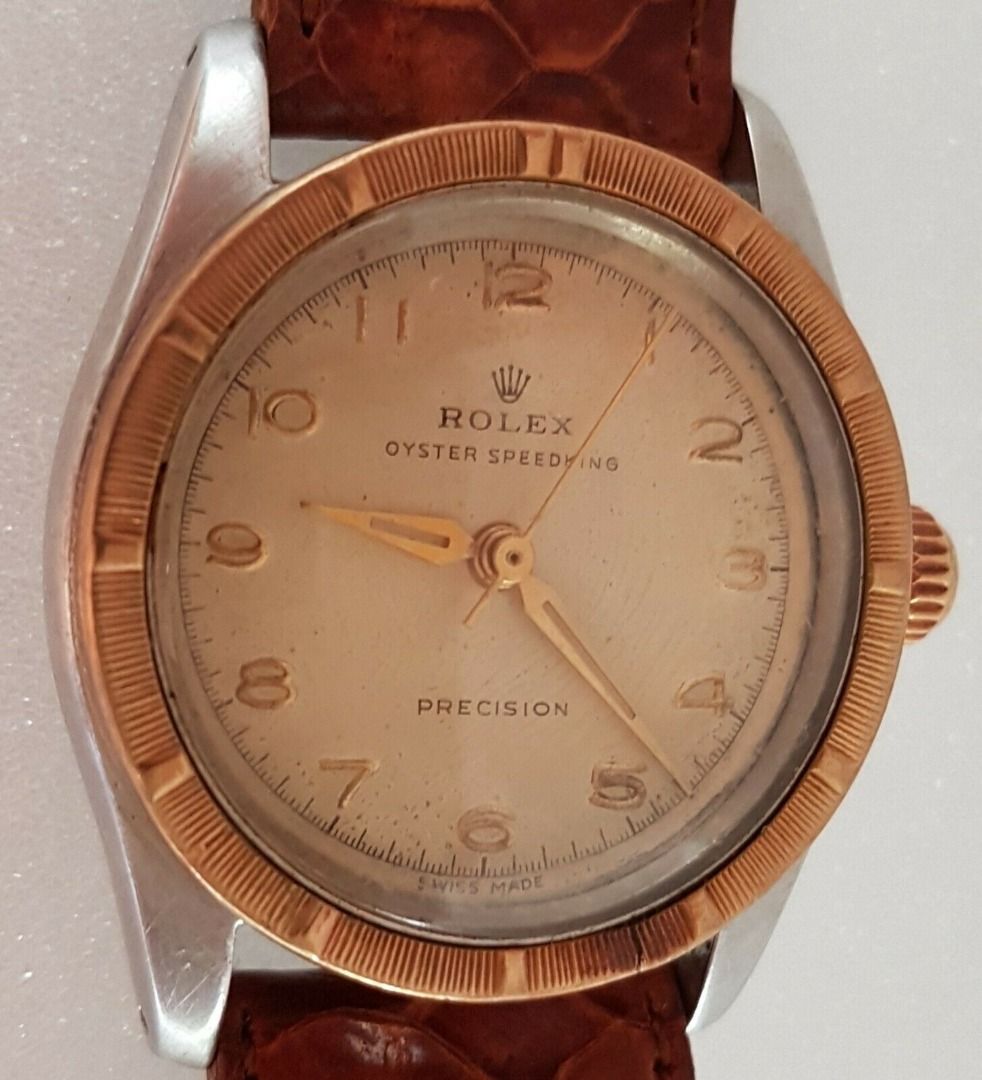 Vintage 1950’s Rolex Speed King Wristwatch, SWISS Made, Distinctive Engine-Turned Bezel, Caliber 5021, Manual Winding Watch, 18 Rubies, Retro 2-Tone Design, Oyster Precision, Tropical Dial, Timeless Classic, Luxury Timepiece, For Collectors, Hobbyists (Category: Watches) located in Singapore. Submitted by discountshop (Listing ID 1453691641, Image 6). Description: The Rolex Speed King is a vintage, manually wound midsize watch, Rolex Oyster Speed