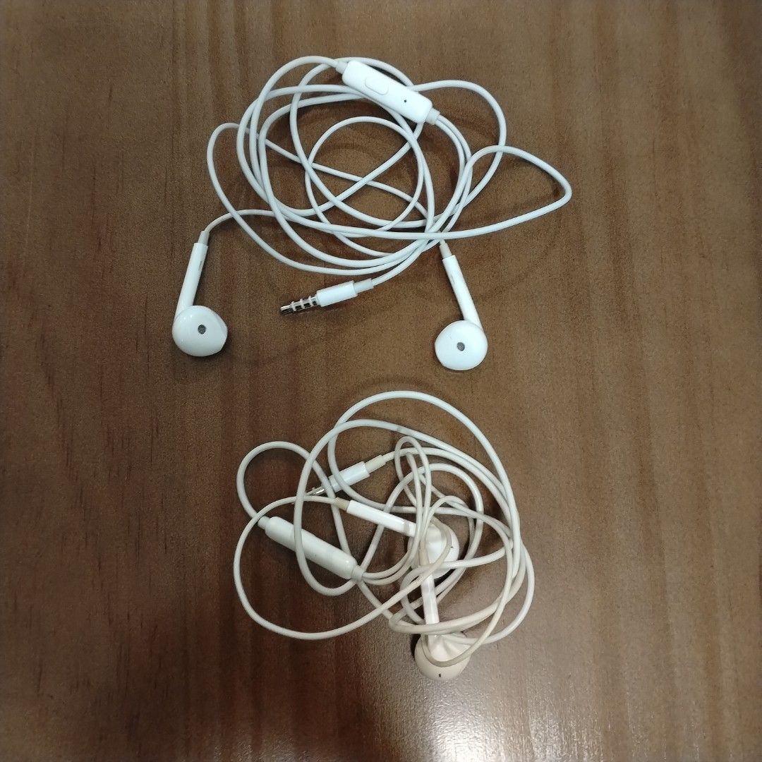 White Wired Earphones with Mic (Category: Headphones & Headsets) located in Singapore. Submitted by adore.tan (Listing ID 1453953503, Image 1). Description: - 2 pairs of white wired earphones - $2 each - Built-in microphones for calls - Standard 3.5mm audio jack compatible with most devices - One pair features a slightly longer cable - Perfect for music and calls - Sold as a bundle.