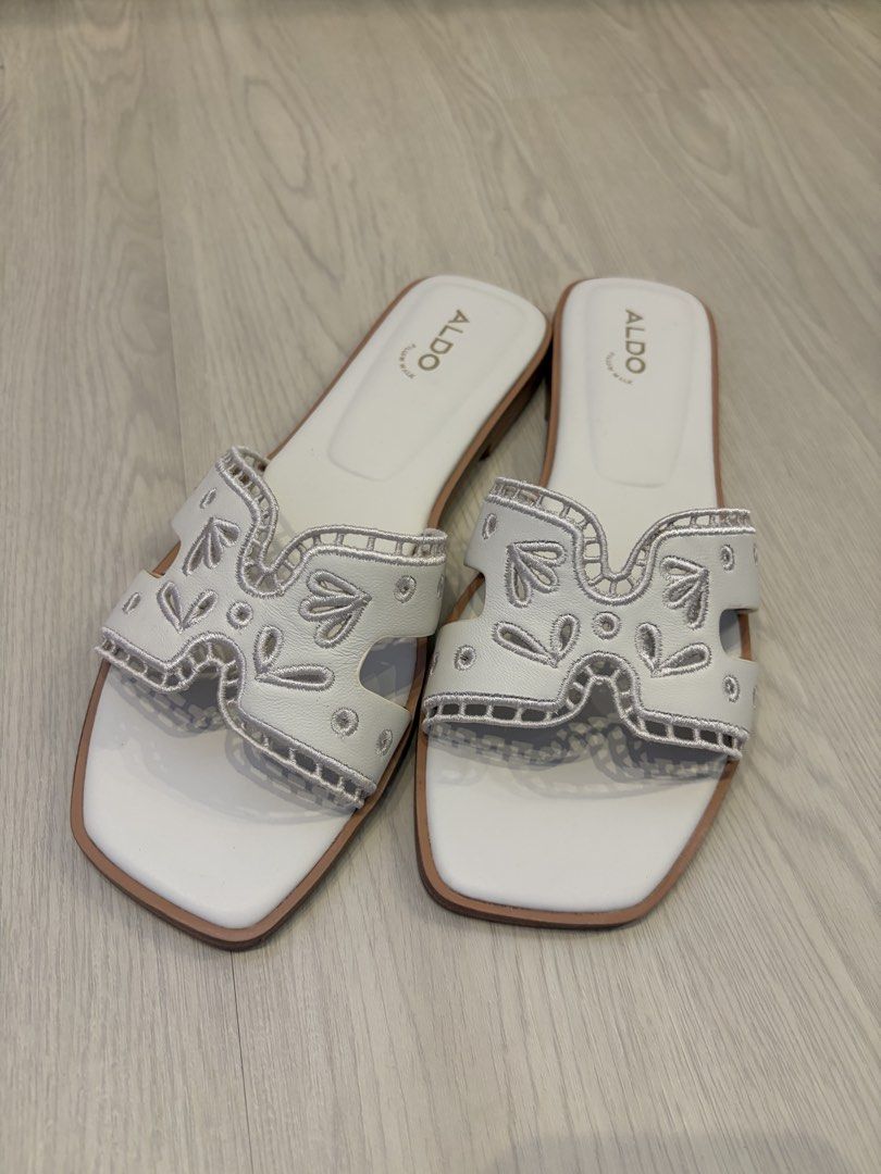 ALDO white Sandals EUR38.5 (fits 39-40) (Category: Sandals) located in Singapore. Submitted by forestfive (Listing ID 1454412315, Image 1). Description: ALDO white flat sandals with cut-out detail and embellishments. Square toe, slip-on style. Comfortable and chic for any occasion. Eur 38.5 (fits eur 39-slim 40) Worn only once. .