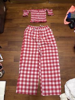 A.193 - The outfit consists of an off-the-shoulder ruched top and wide-leg pants with a youthful red and white gingham pattern.